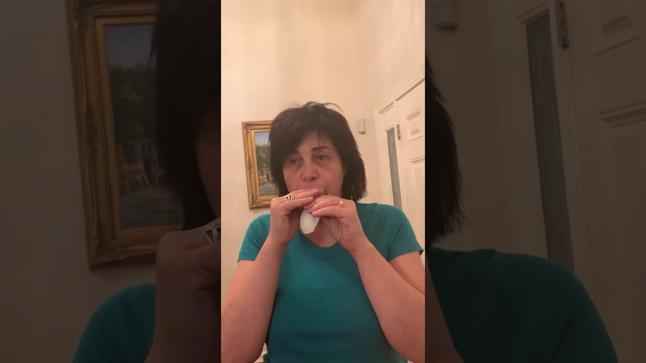 Girl blowing up a white balloon