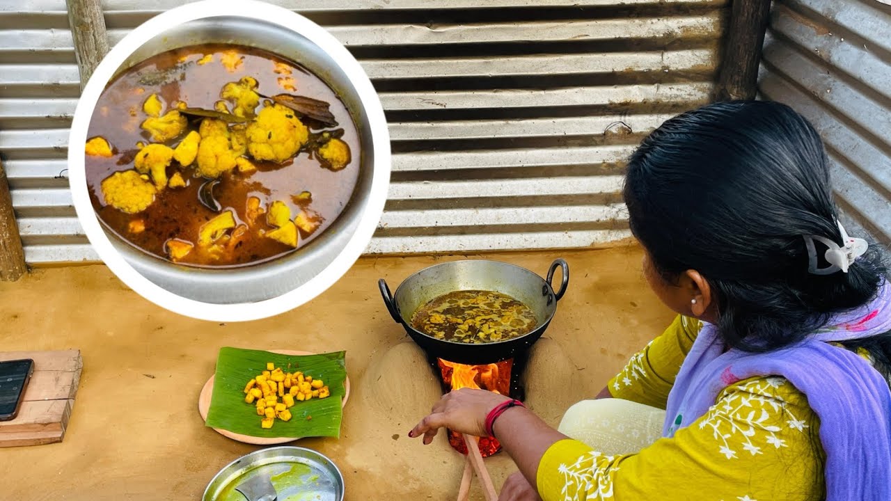  She is cooking cauliflower curry with cheese