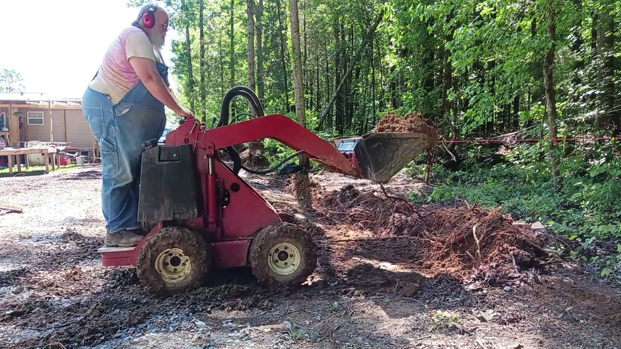 Digging a shallow Drainage ditch with a Toro Dingo 222