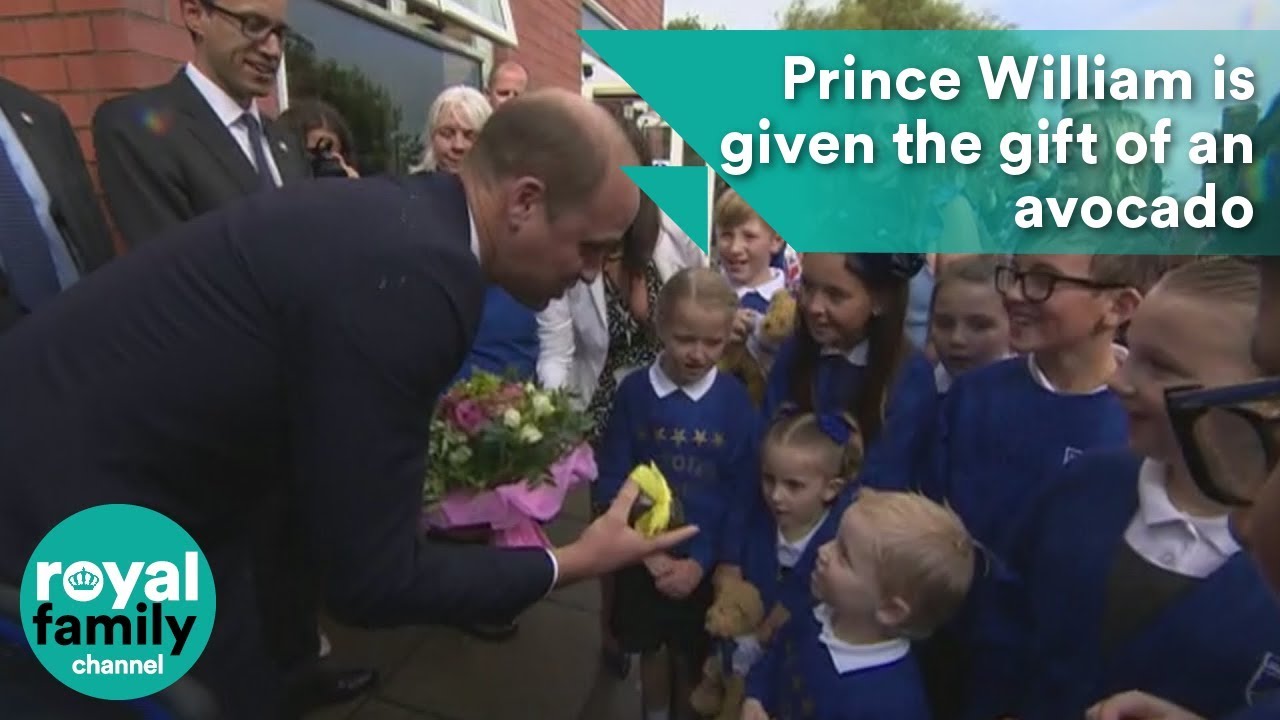 Prince William is given the gift of an avocado by a young boy