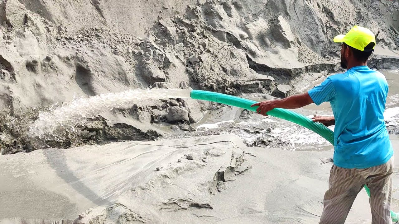 Incredible Power of Water: Worker Washes Away a Mountain of Sand with a High-Pressure Hose