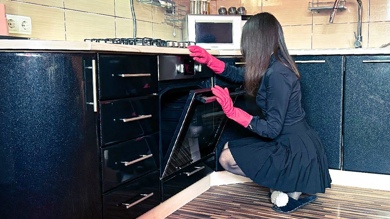 Cleaning the oven and microwave using Spontex pink rubber gloves