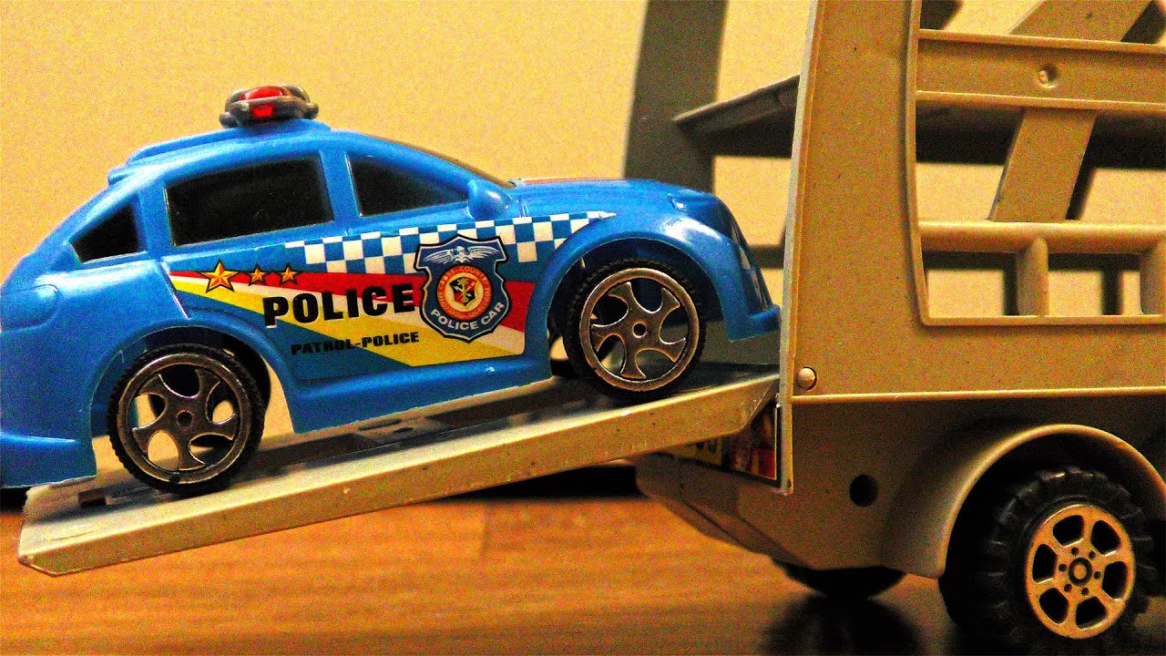 Various Plastic Toy Cars Carried by Transportation Vehicles