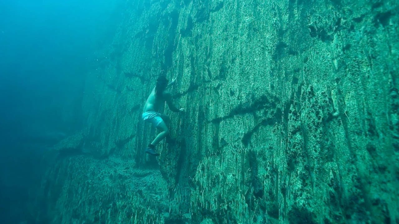 Underwater Rock Climber Scaled Limestone Wall