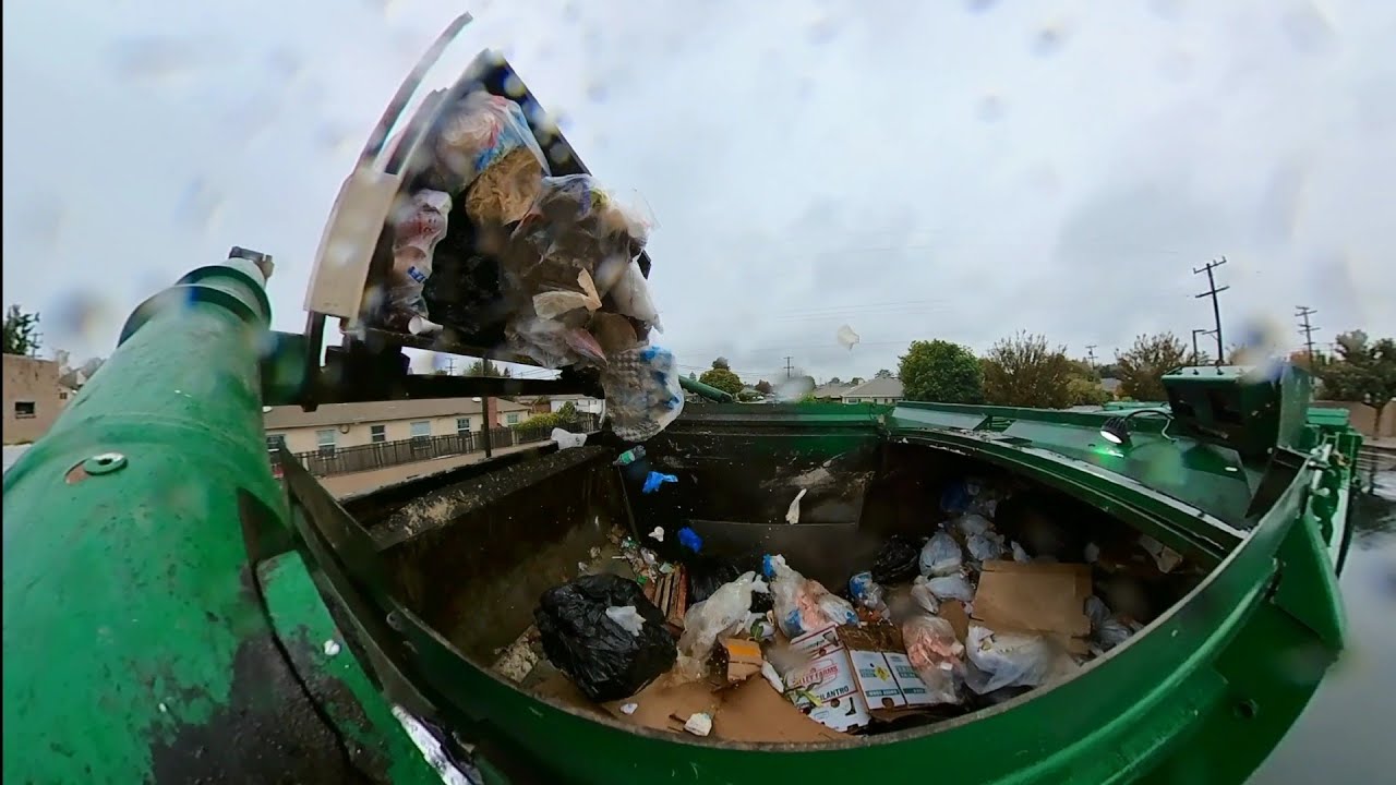 Waste Management garbage truck dumping bins