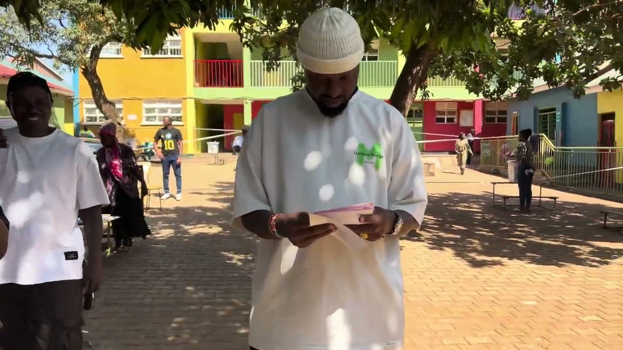 Eddy Kenzo casts his vote for President Museveni and other leaders at his polling station.