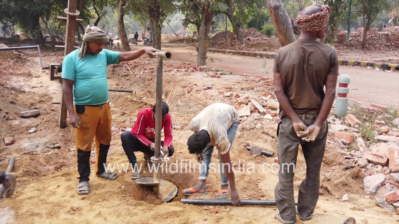 Indian labourers drill borewell manually || Manual borewell drilling machine || Borehole digging