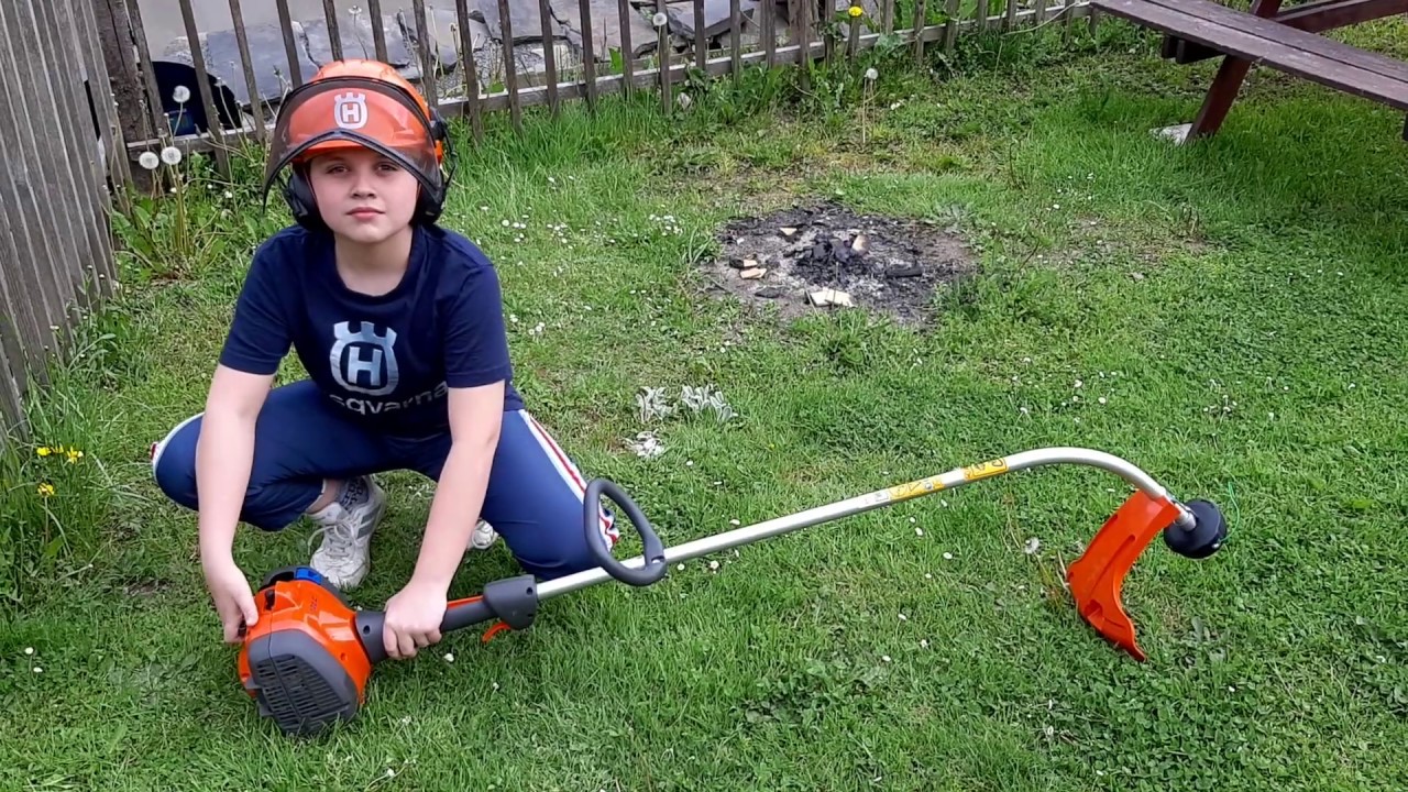 The first mowing of the grass with a Husqvarna 122C trimmer