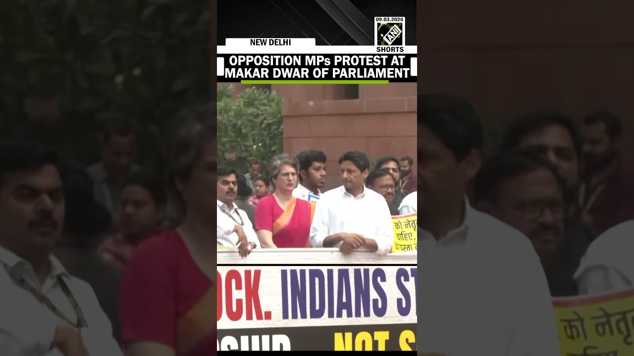 Suspended Opposition MPs protests at makar dwar of Parliament with placard