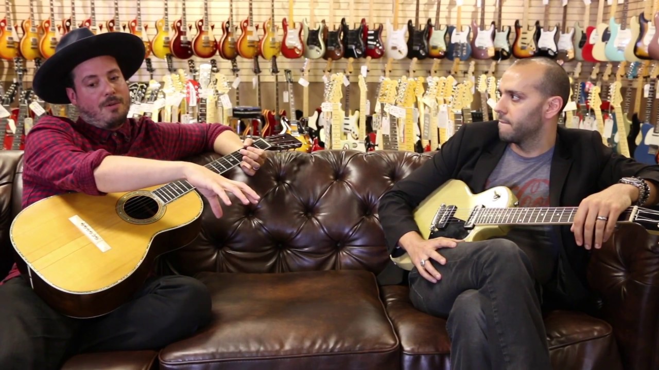 Jared Gutstadt from Jingle Punks on the couch with Mark Agnesi at Norman's Rare Guitars