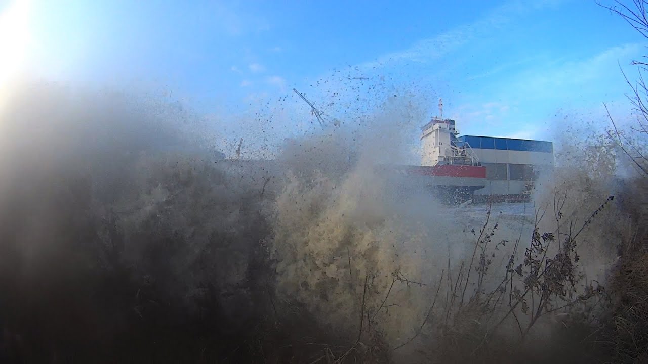 Big tsunami wave caused by a sideways ship launch smashes the camera
