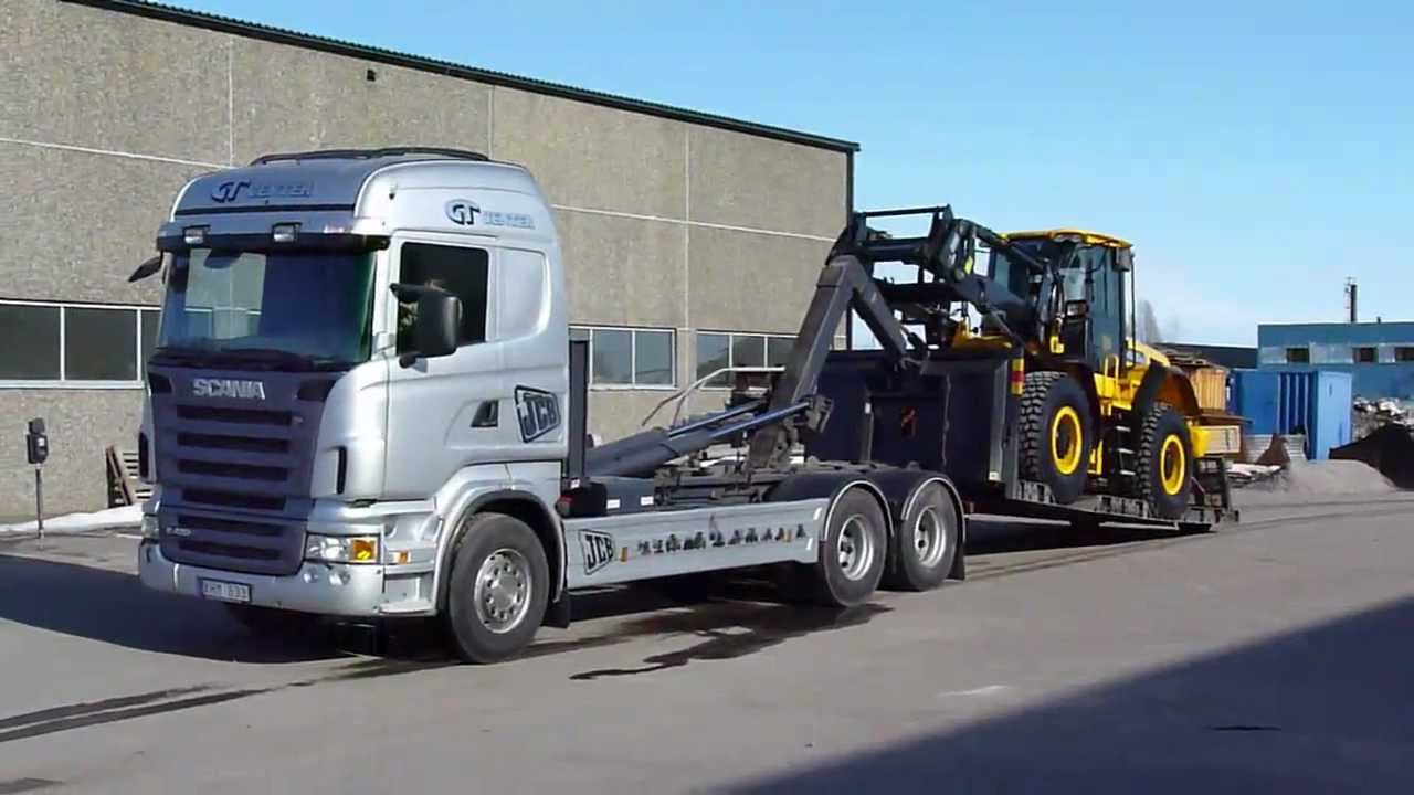 Scania R420 Hook lifter  unloading a new JCB426E Weelloader