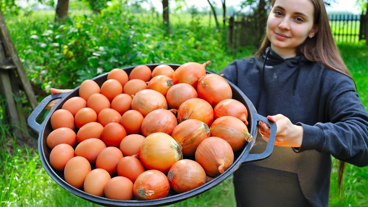 Old traditional onion pancakes recipe, Ukrainian girl cooks in the village