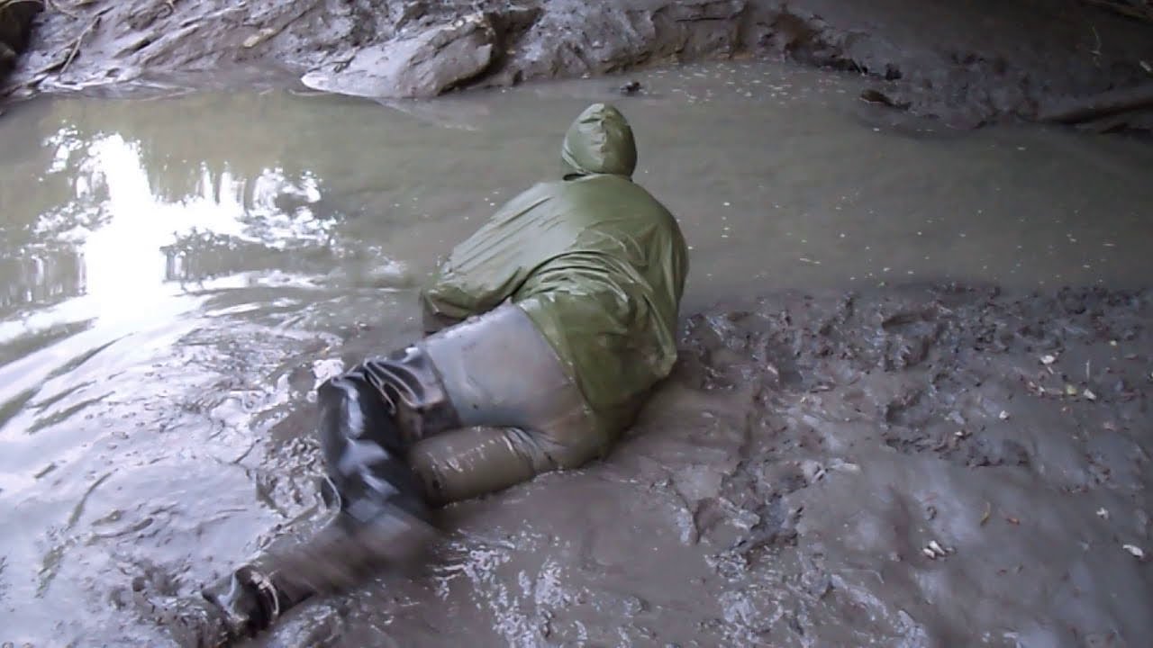 In mud fully clothed