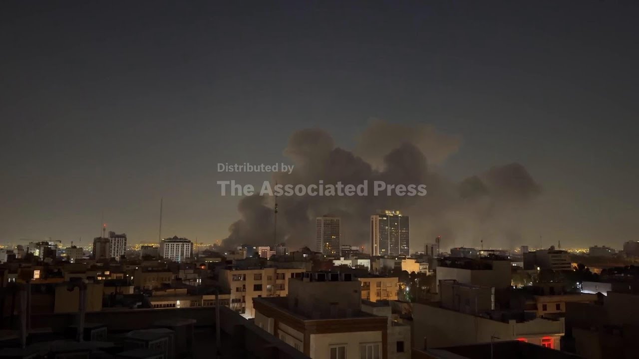 Plumes of smoke rise in the air as airstrikes rock Tehran at dawn