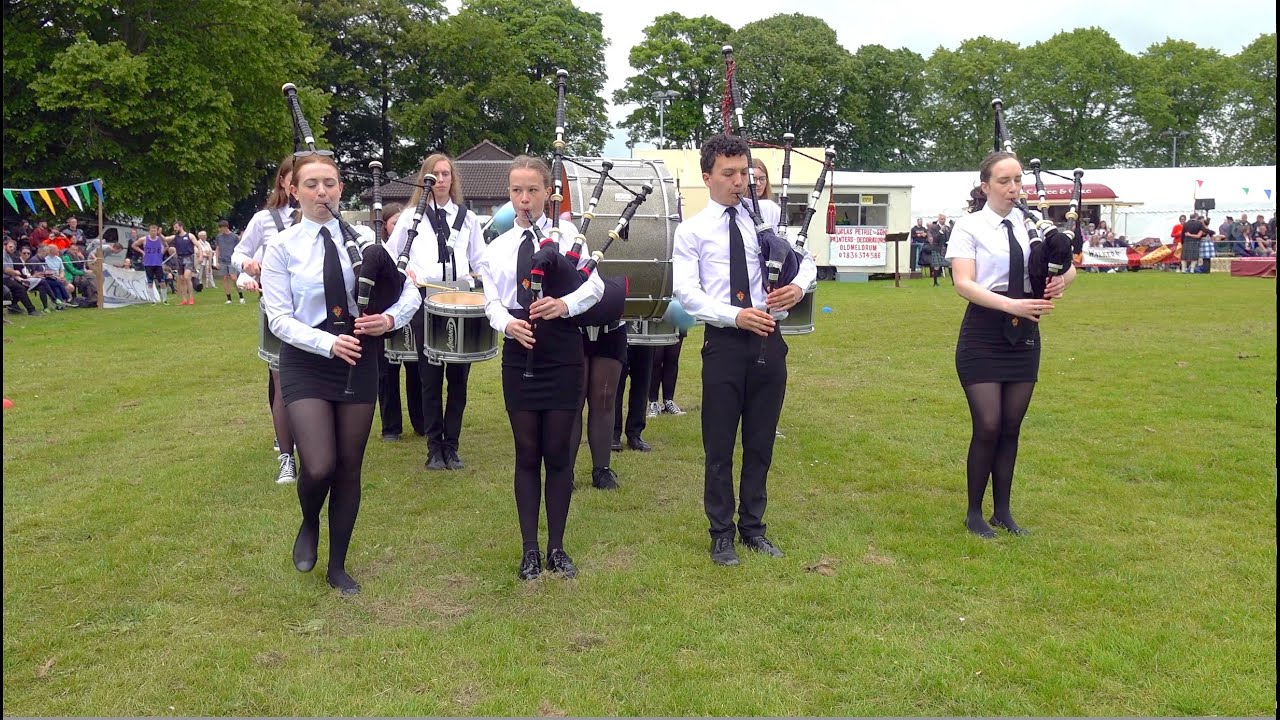 Meldrum Academy Pipe Band march in playing Scotland the Brave at 2024 Oldmeldrum Highland Games
