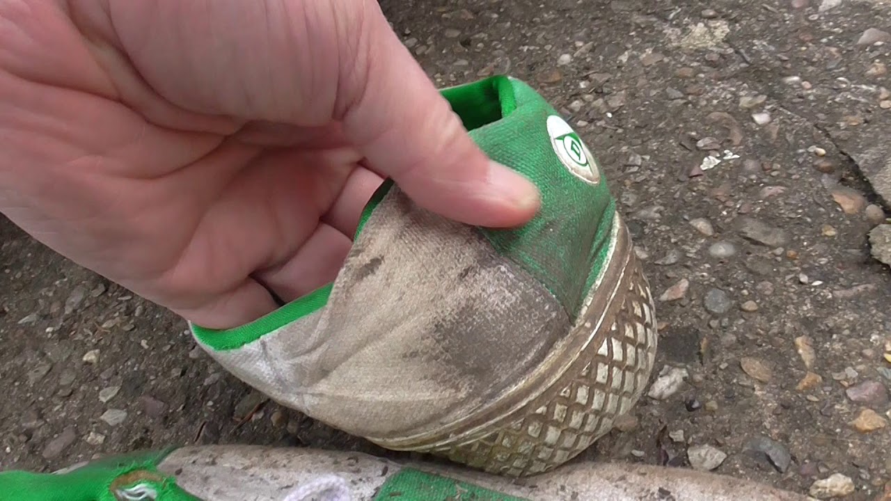 Squashing  Dunlop Green Flash plimsolls under car wheel