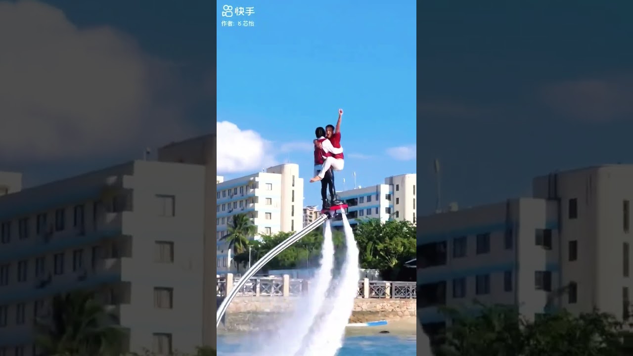 A woman giving a lift carry ride to a man on a water powered flyboard