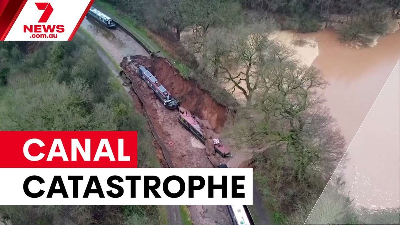 Massive sinkhole swallows boats in UK canal collapse | 7NEWS