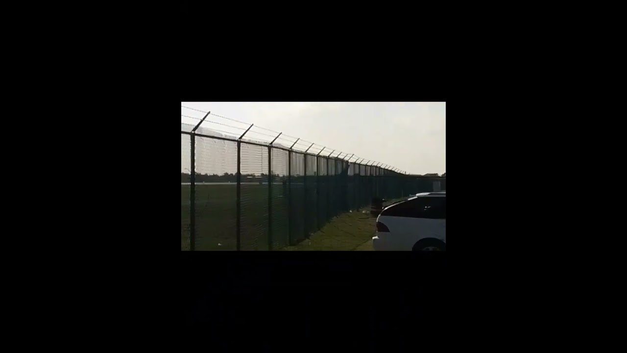 Cayman Airways landing and American Airlines takingoff