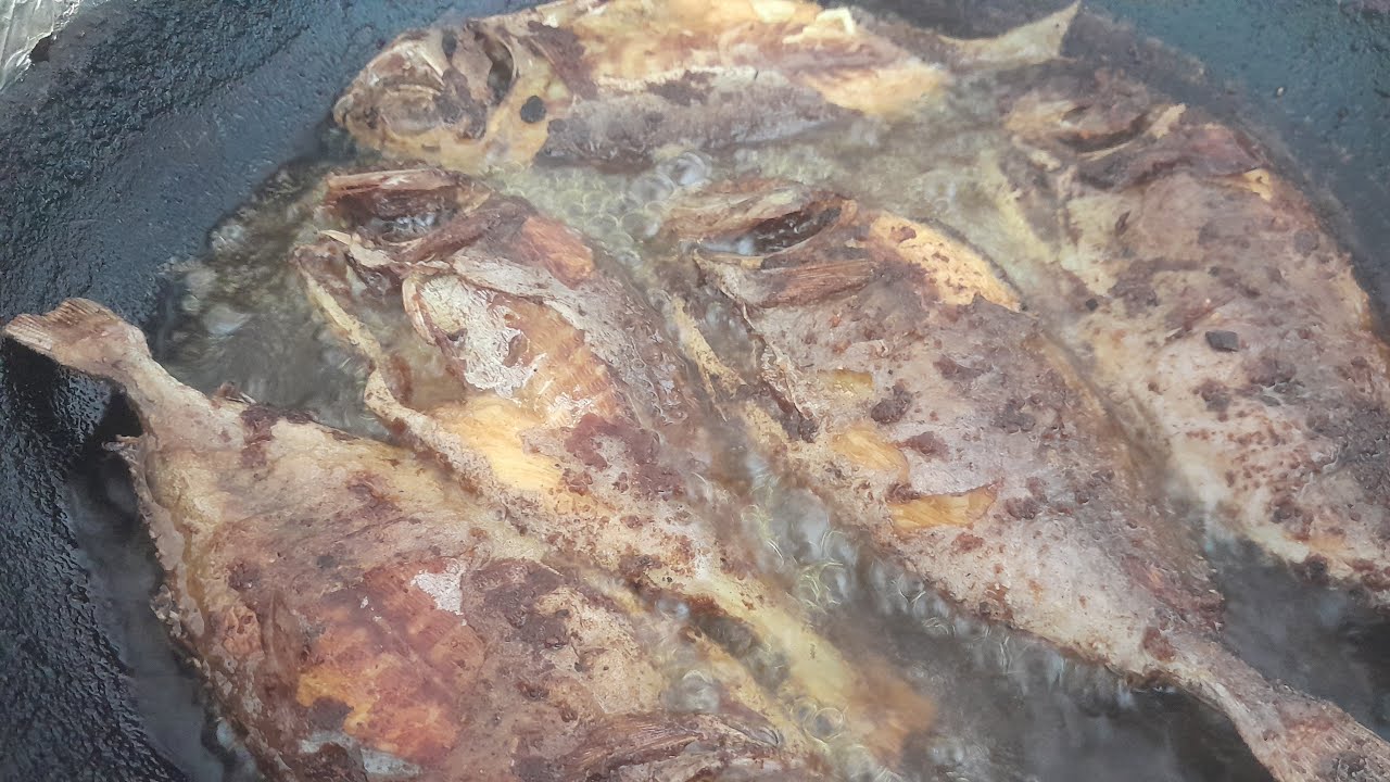 cooking fish in the antique frying pan