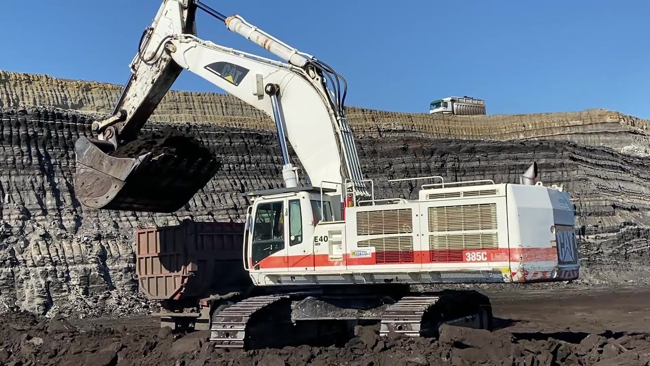 White Caterpillar 385C Excavator Loading Coal On Trucks - Interkat SA