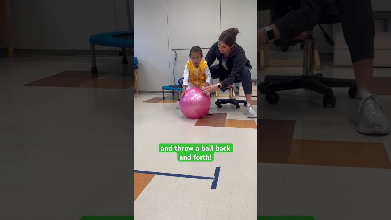 Child with Angelman syndrome learns how to throw ball