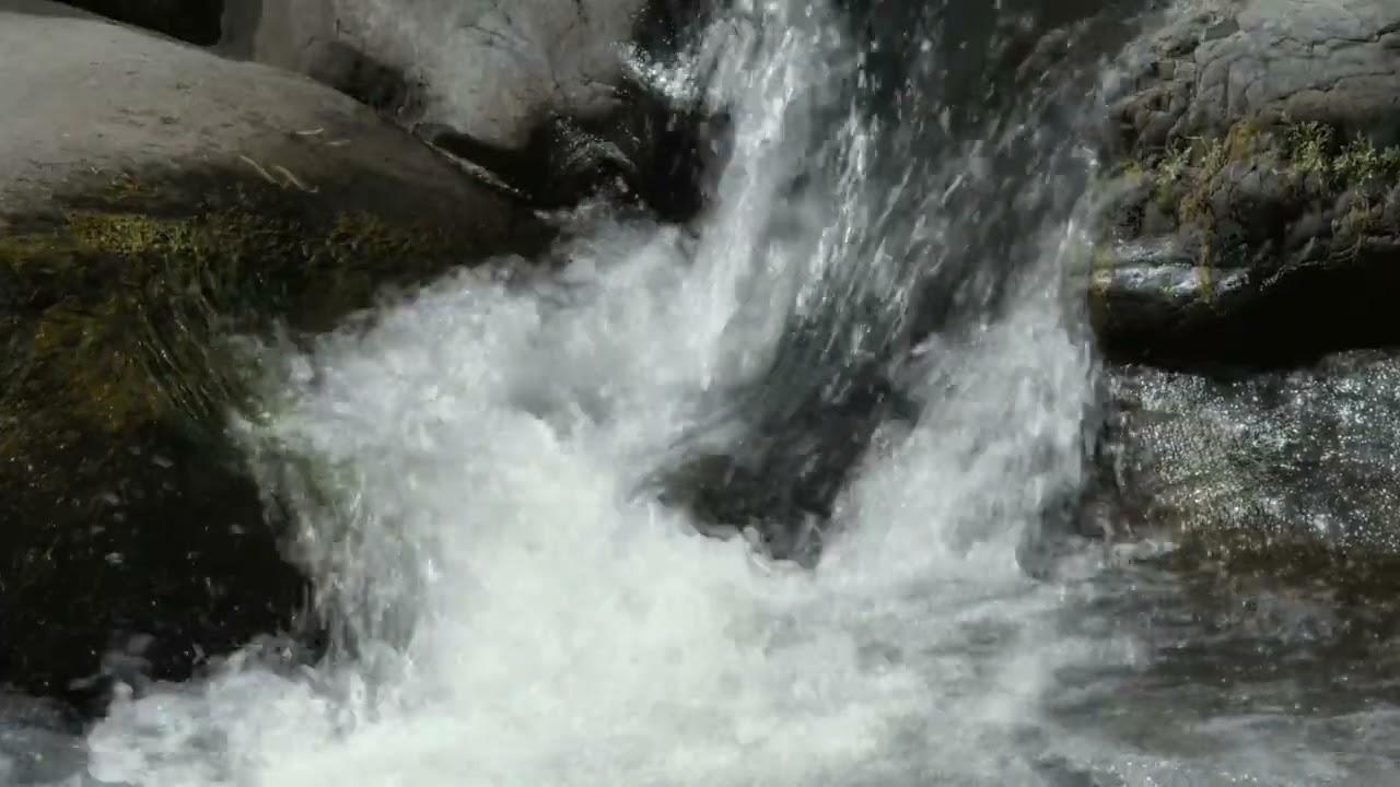 Relaxation of a river flowing rapidly between rocks to calm the mind and relieve anxiety