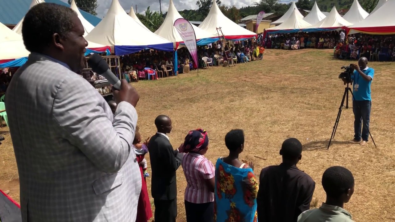 Canon Dr Medad Birungi praying for the couples who decided to marry