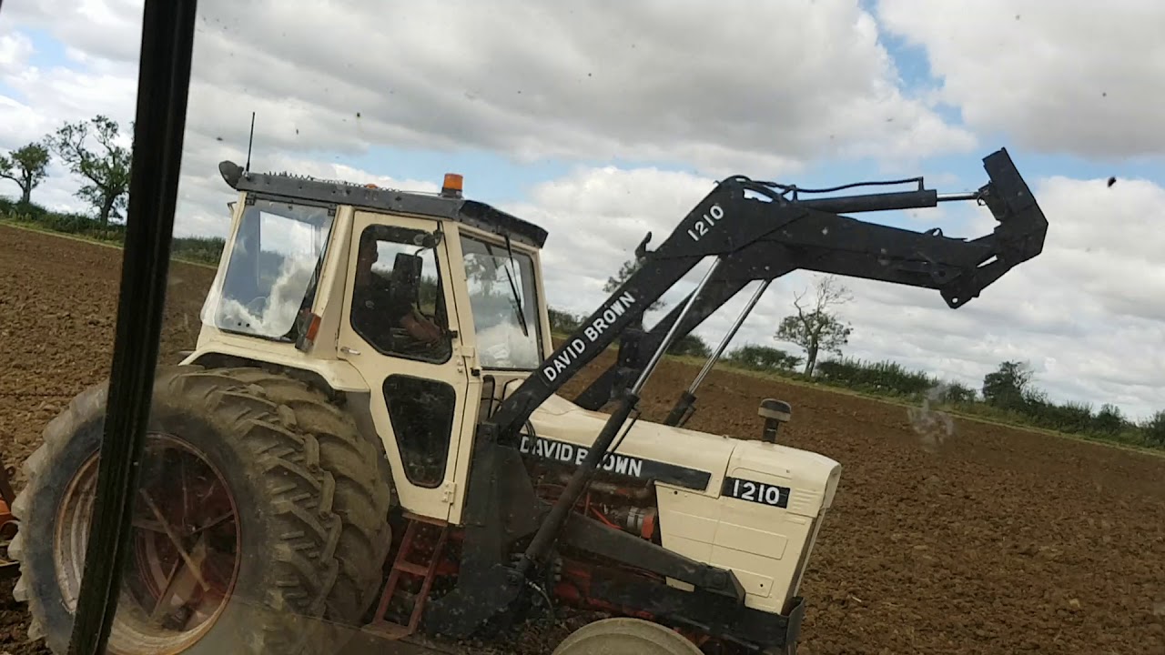 David Brown 1210 with duel wheels and 16 ft spring tine harrow