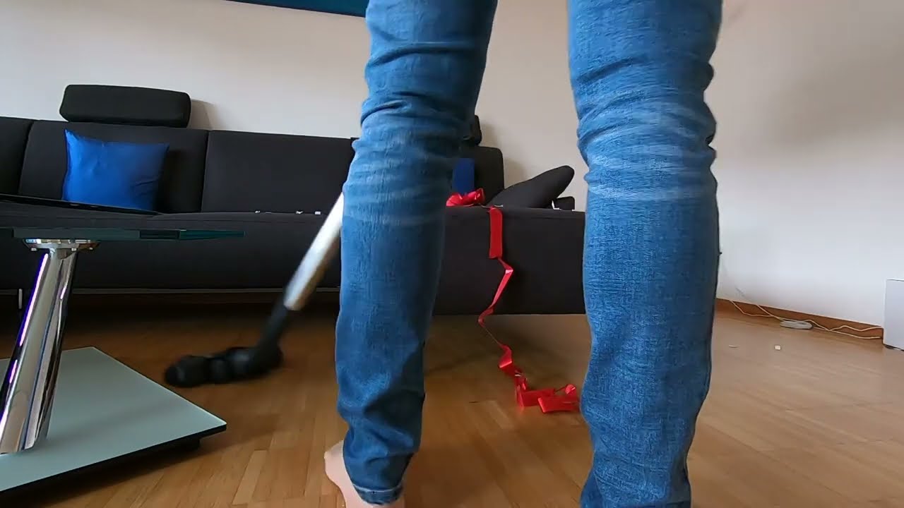 Vacuuming the living room in the afternoon after kids were playing