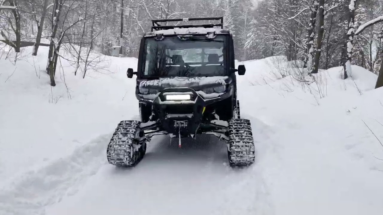CAN AM Defender Max Limited towing a snow groomer