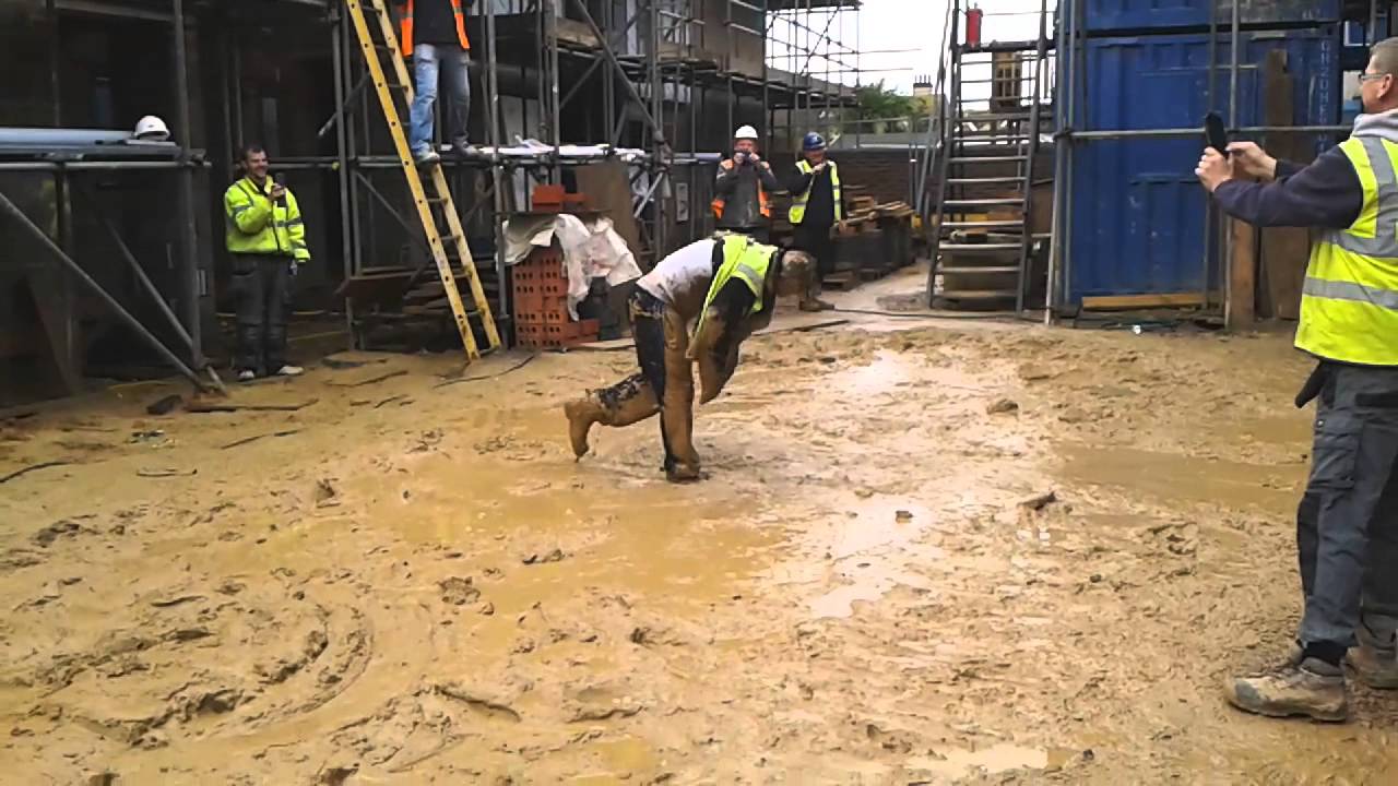 Funny Stunt by Construction Worker, Labourer, Callum throws himself into sloppy Mud on Building site