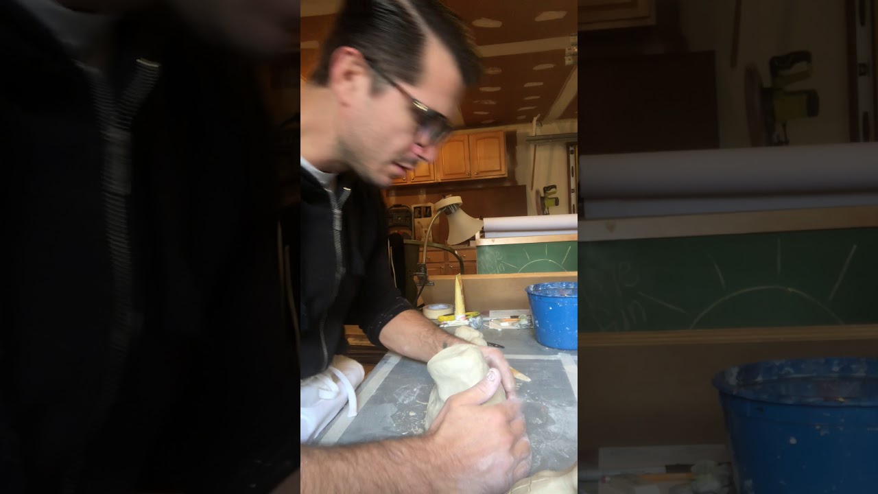 Sculpting a neck and shoulders in clay