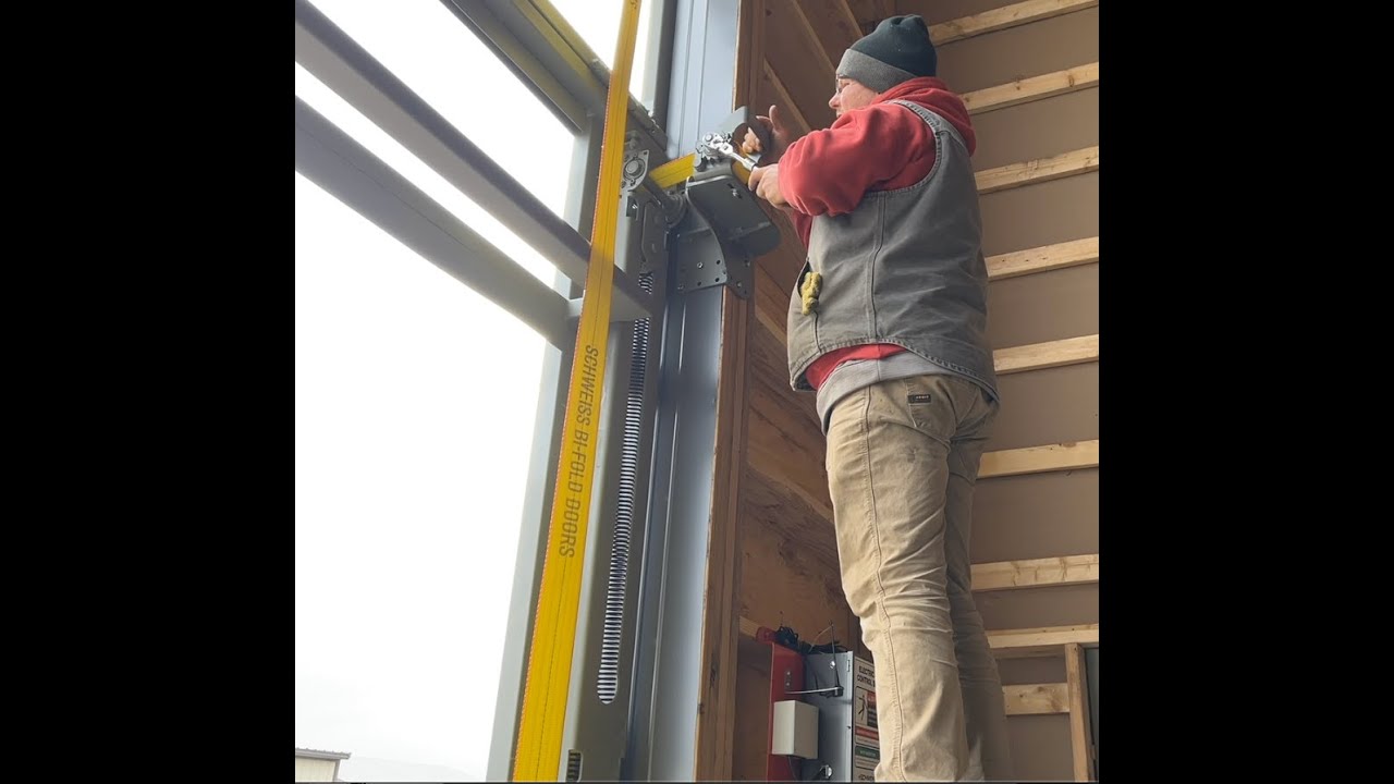 Schweiss Crew Installs Strap Latch on 50' x 18' Strap Bifold Door