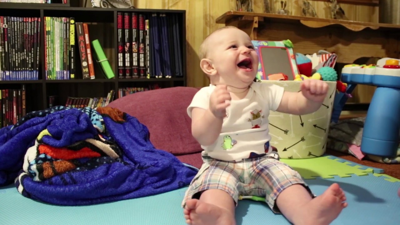Baby laughs so hard he falls down!