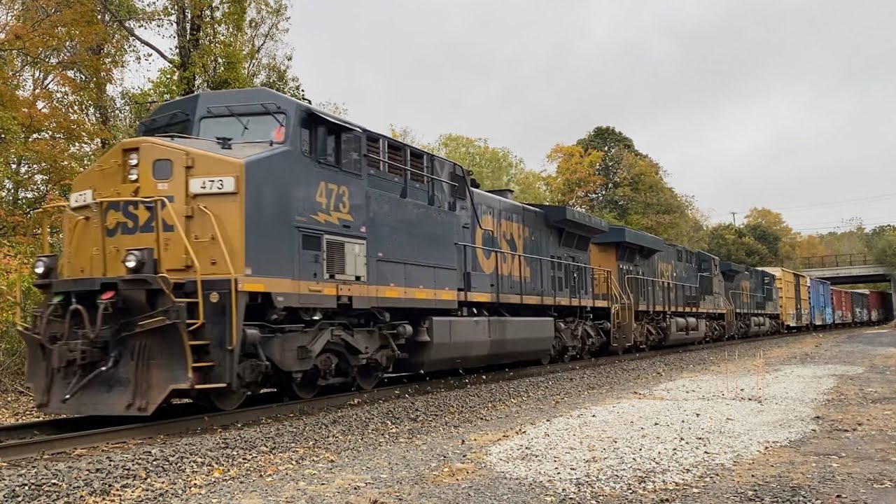 CSX M827/13 flies past CP57 with AC44 #473 leading