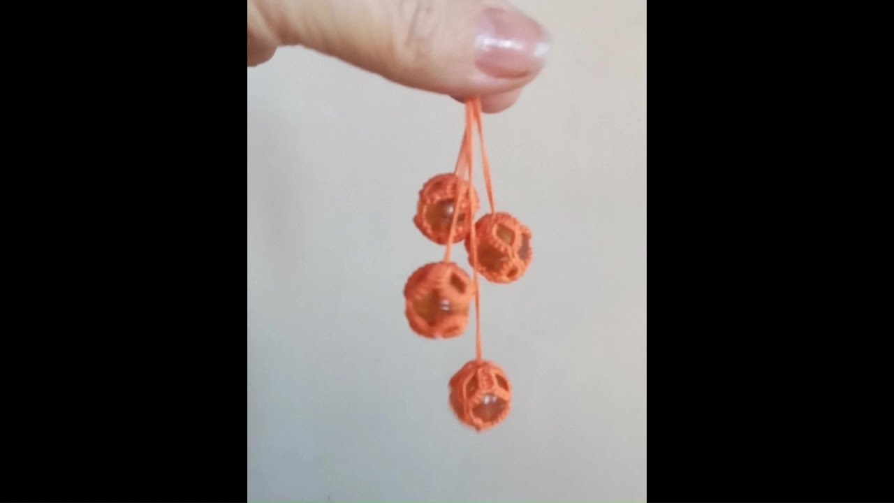 Needle tatting. Bead inside a lace ball