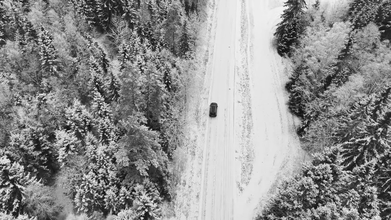 Aerial View of Snowy Forest Road in Sweden