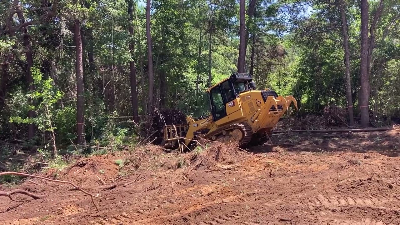 Cat 963 taking down trees