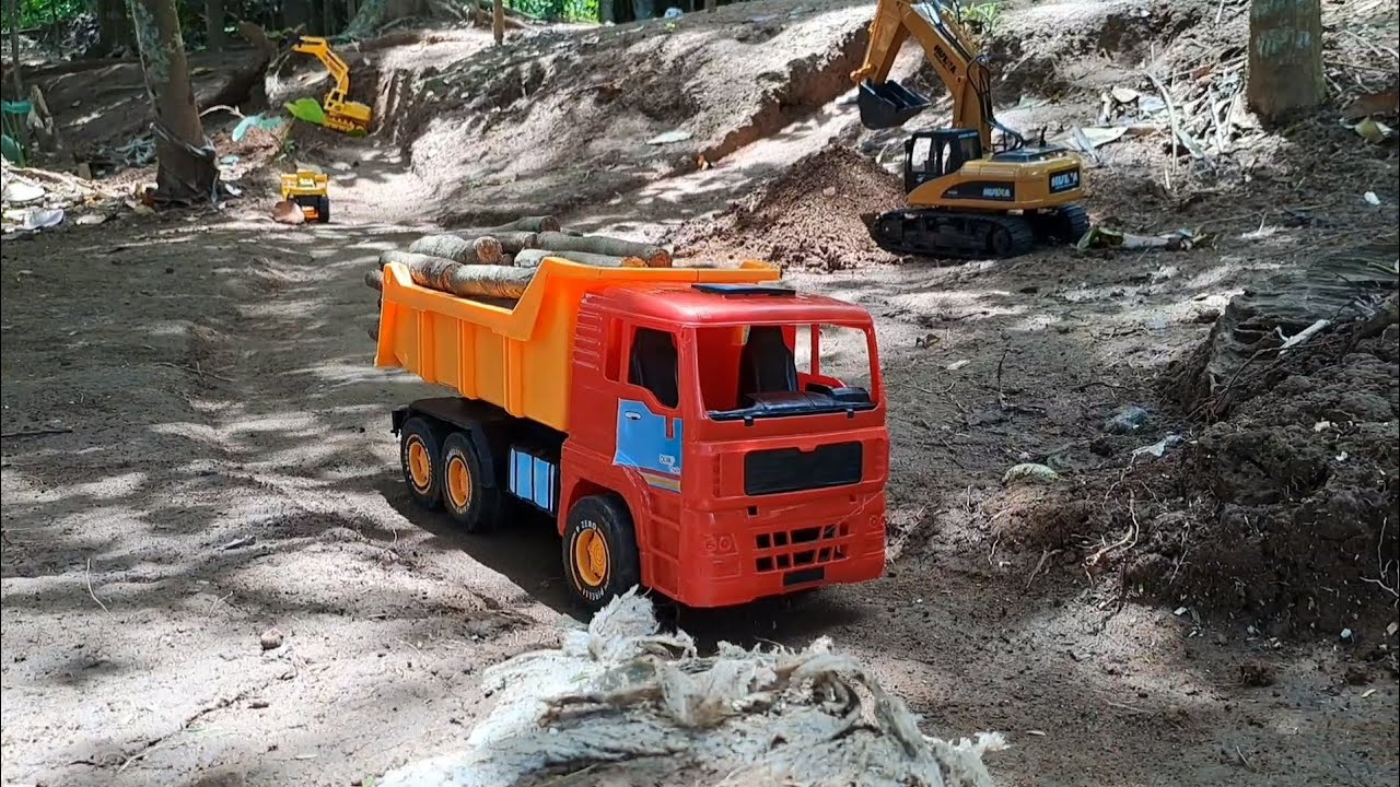 Dump Truck Orange OCT 6001 Muat Kayu Gelondongan