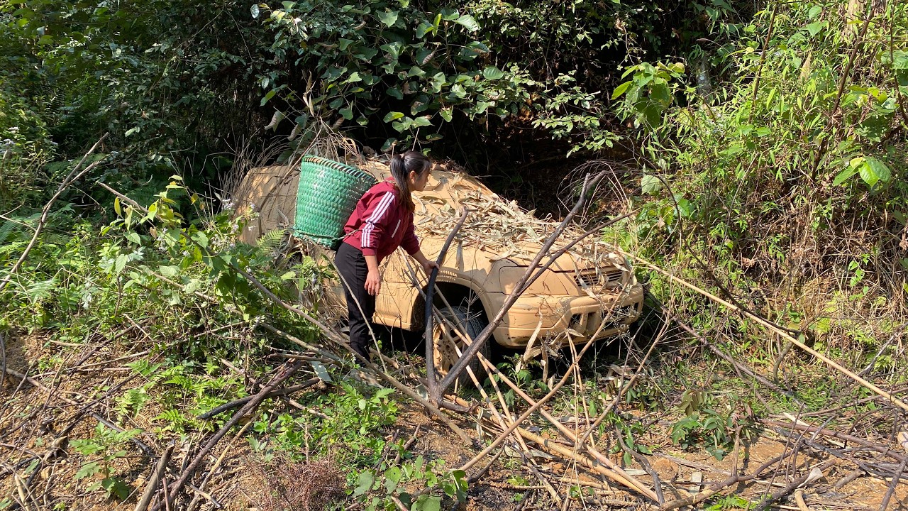 The girl repairs and restores a classic 1995 Honda CR-V that has been abandoned in the woods.