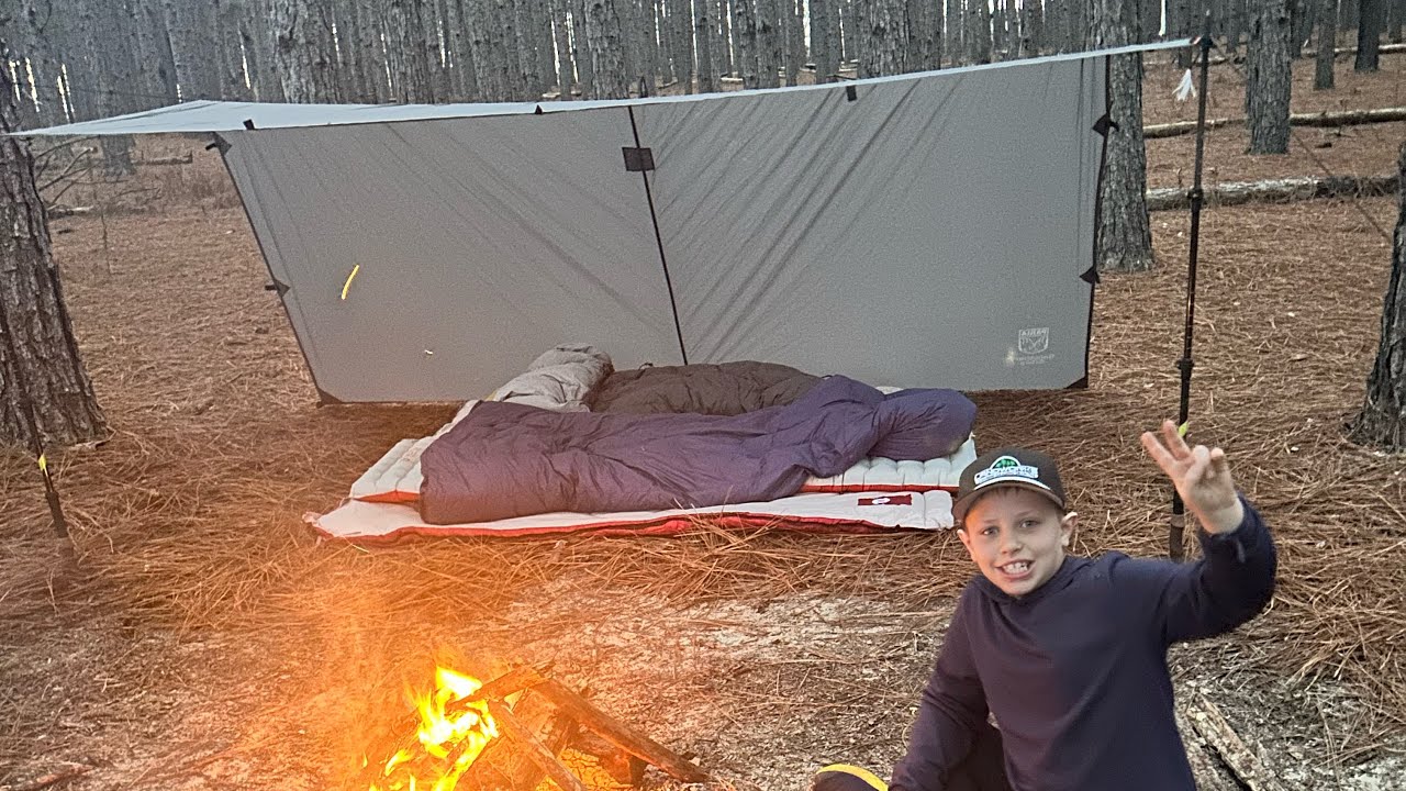 Father and son cold weather camping and cooking. 