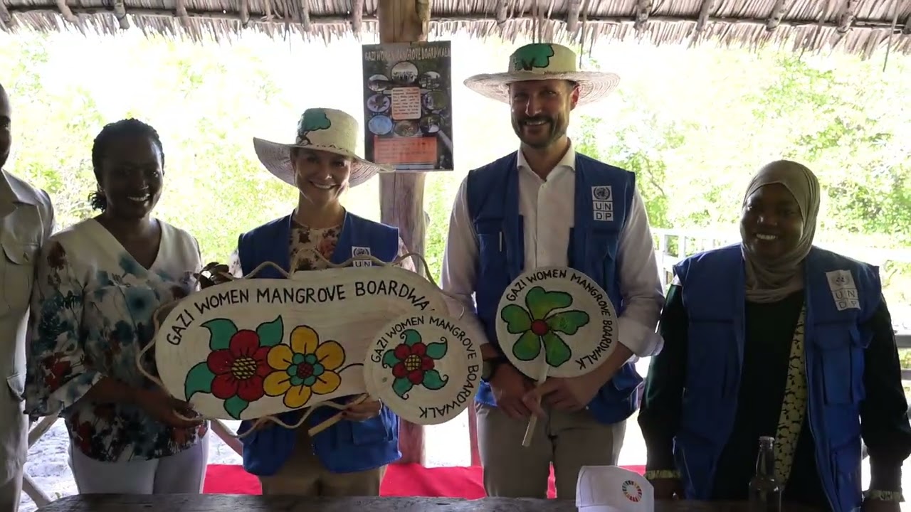 Crown Princess Victoria and Crown Prince Haakon dressed up in african hats and dresses