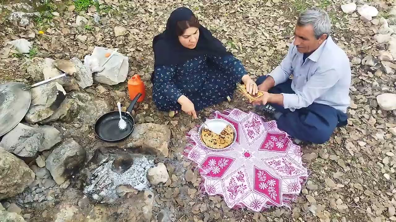 A nomadic woman and her husband cooking an ancient pizza🍕🔥#cooking #food #nomadicfamily 