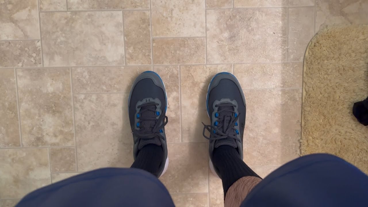 Wet Grey Under Armour Charged Assert 9 Running Shoes in the Bath