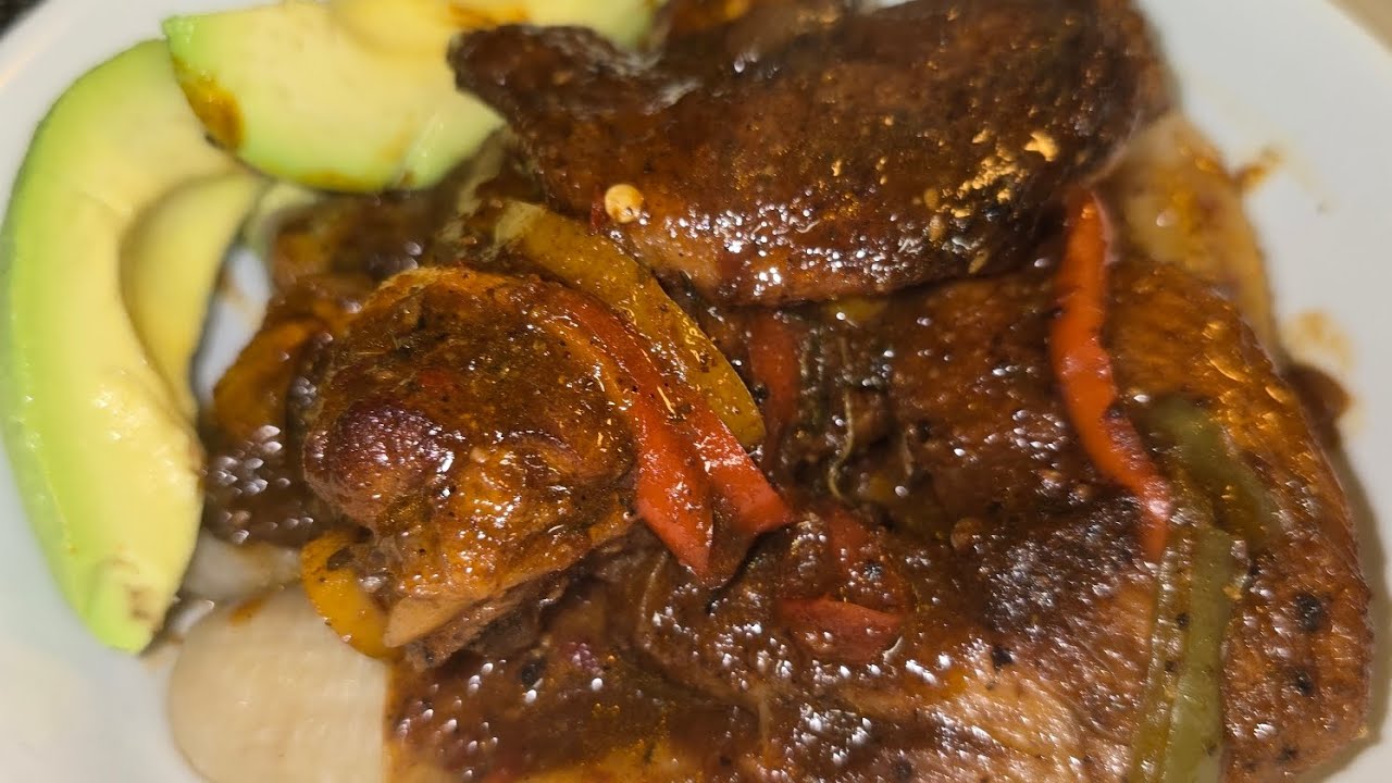 Brown strew chicken wings with green banana and avocado 