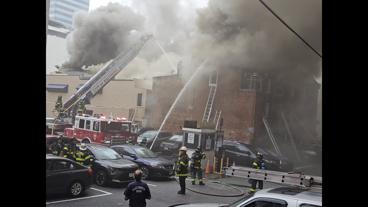 Baltimore City Fire officials battle a 5 alarm building fire Sunday morning on Lombard Street