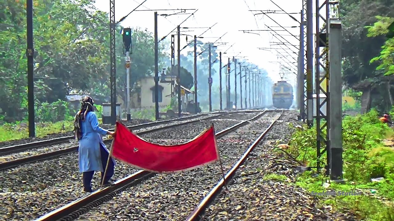 Lady Gangman showing Red signal to Sealdah-Ranaghat Memu special passenger Train