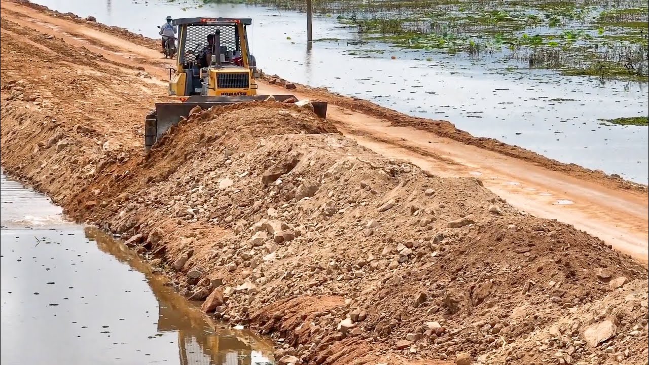 Strong Komatsu Bulldozer Working On a Long Road with 25T Dump Trucks